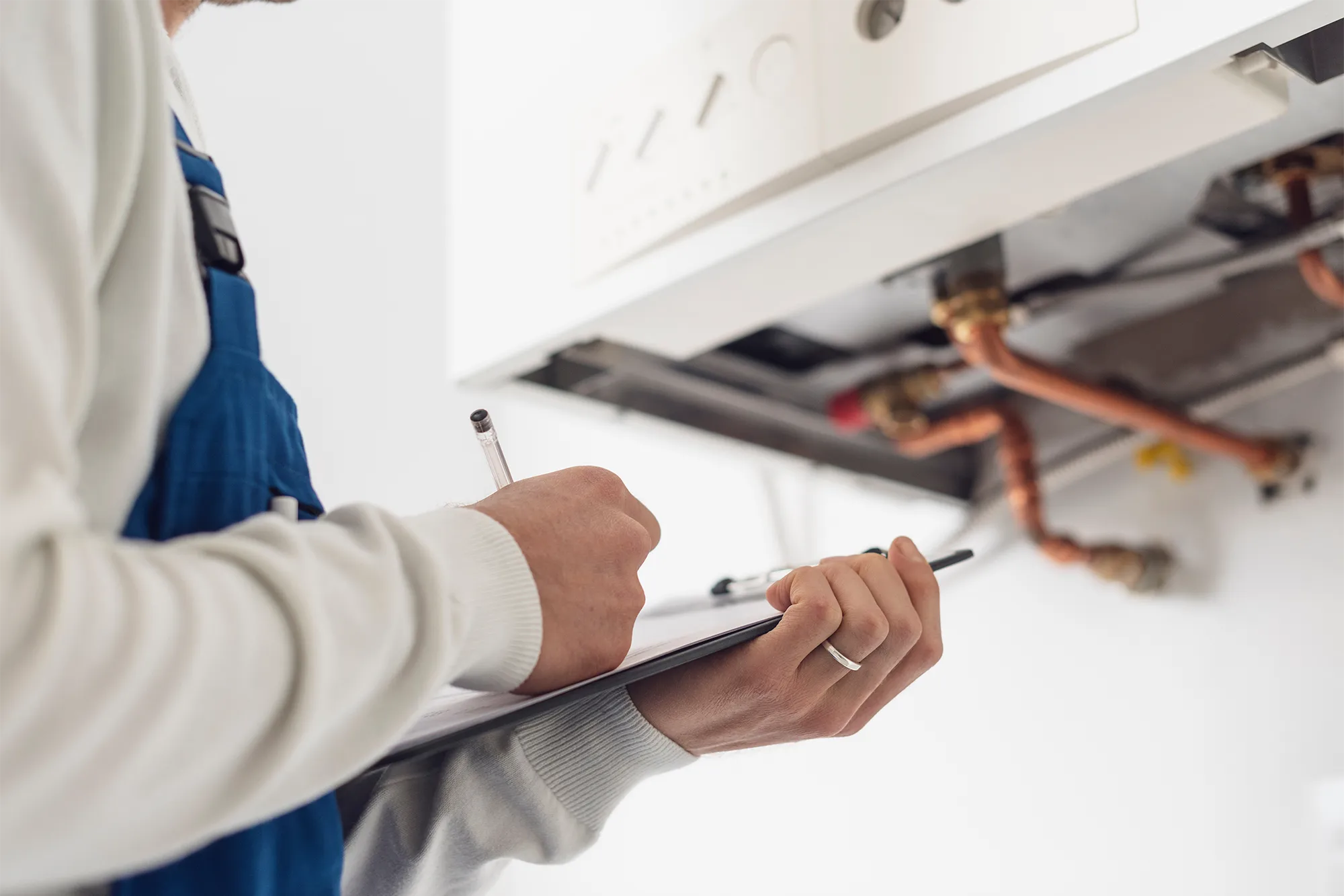 man inspection a boiler with checklist